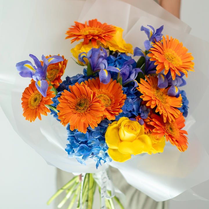 Bouquet "Sunny Symphony" with gerberas, irises, yellow roses, and hydrangeas