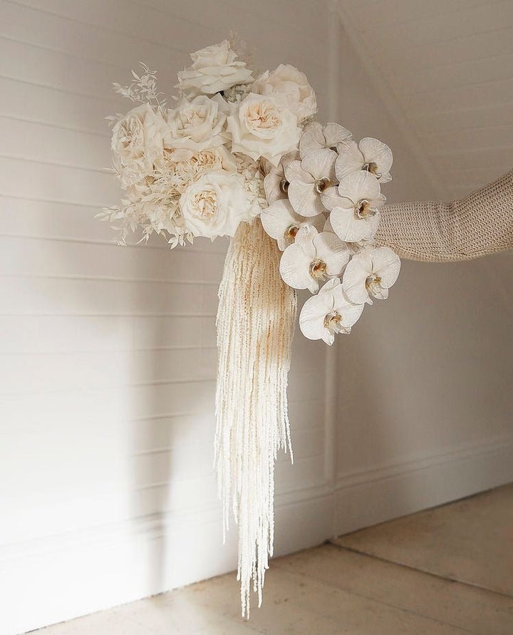 Bridal bouquet with peony, roses and dried amaranth