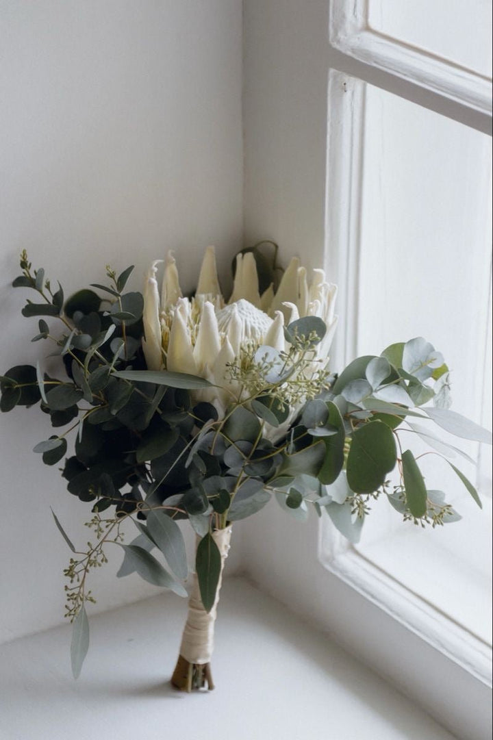 Bridal bouquet with protea and greenery