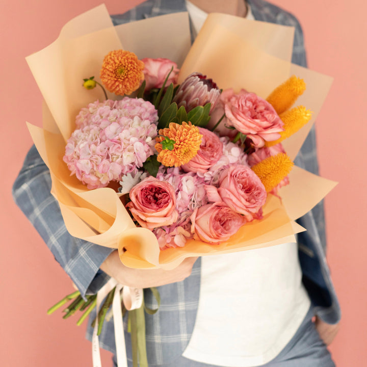 Bouquet "Sunset Serenade" with roses, ranunculus, hydrangea and mums