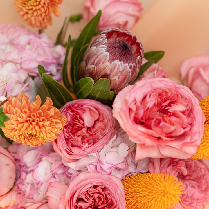 Bouquet "Sunset Serenade" with roses, ranunculus, hydrangea and mums