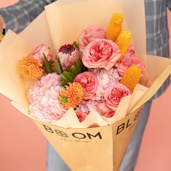 Bouquet "Sunset Serenade" with roses, ranunculus, hydrangea and mums