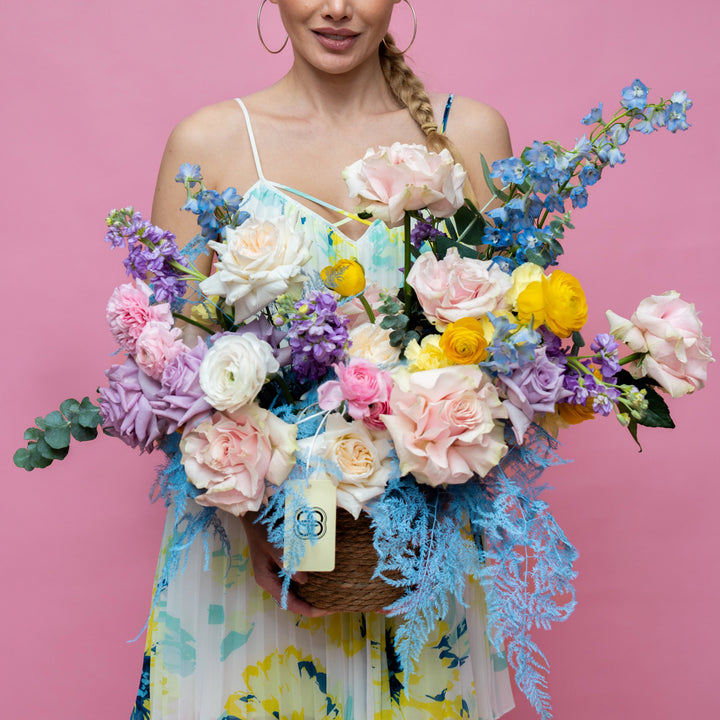 Flower basket "Rainbow" with roses and ranunculus