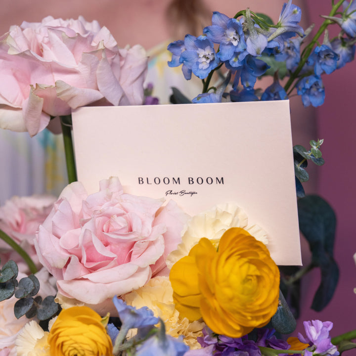 Flower basket "Rainbow" with roses and ranunculus