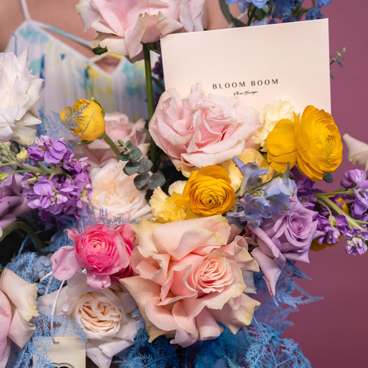 Flower basket "Rainbow" with roses and ranunculus