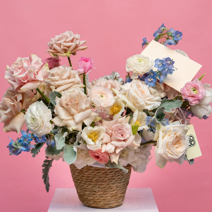 Flower basket "Foggy" with ranunculus and roses