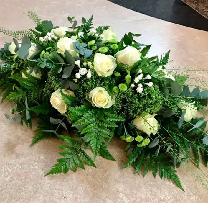 Custom funeral floral tributes crafted within a $200 budget.